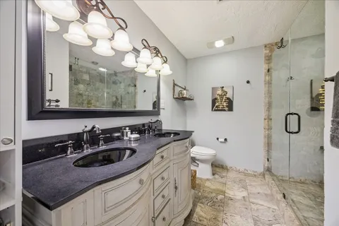 a bathroom with a sink a toilet and a mirror