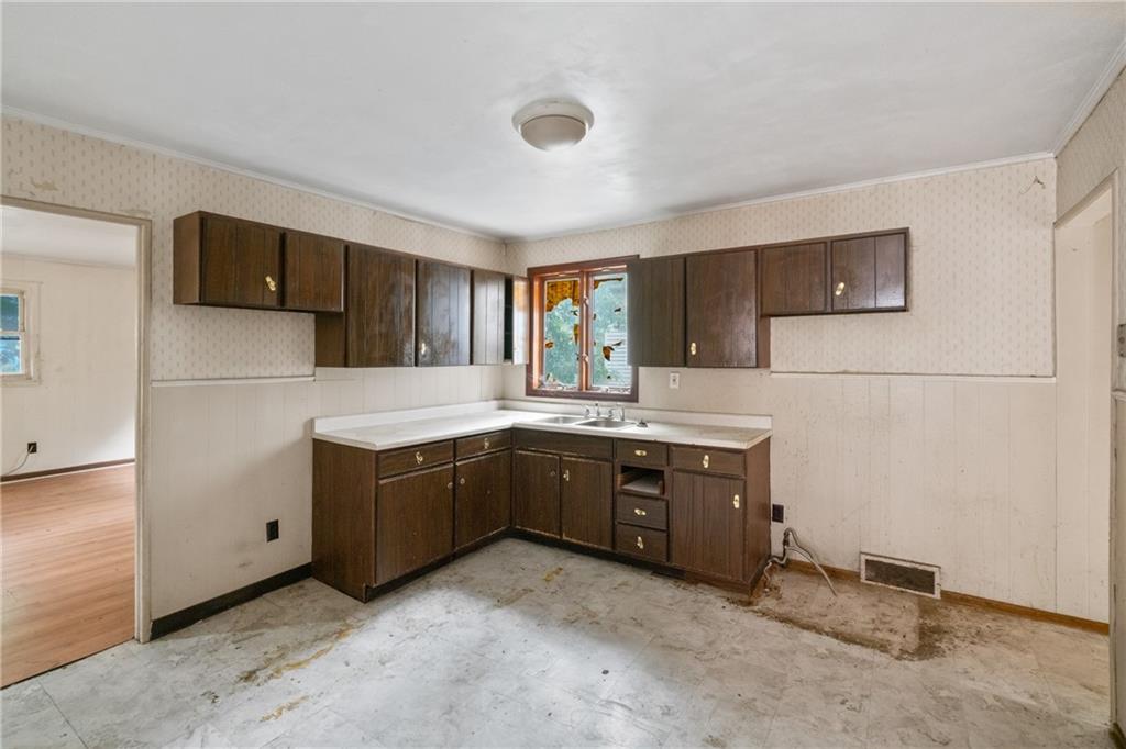 525 Larimer Avenue Turtle Creek, PA 15145 - Photo 20 of 28 a kitchen with stainless steel appliances granite countertop a refrigerator and a stove top oven