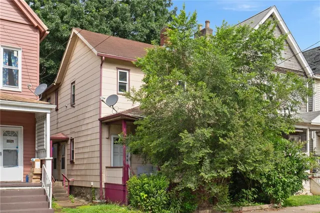 a view of a house with a tree