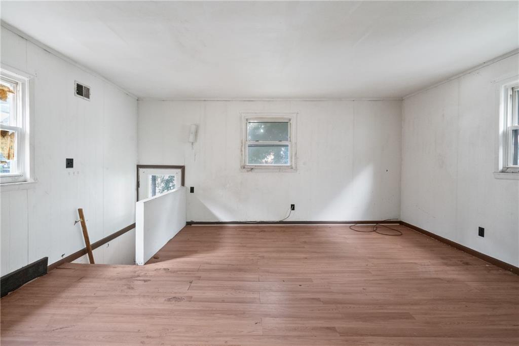 525 Larimer Avenue Turtle Creek, PA 15145 - Photo 21 of 28 a view of empty room with wooden floor and window