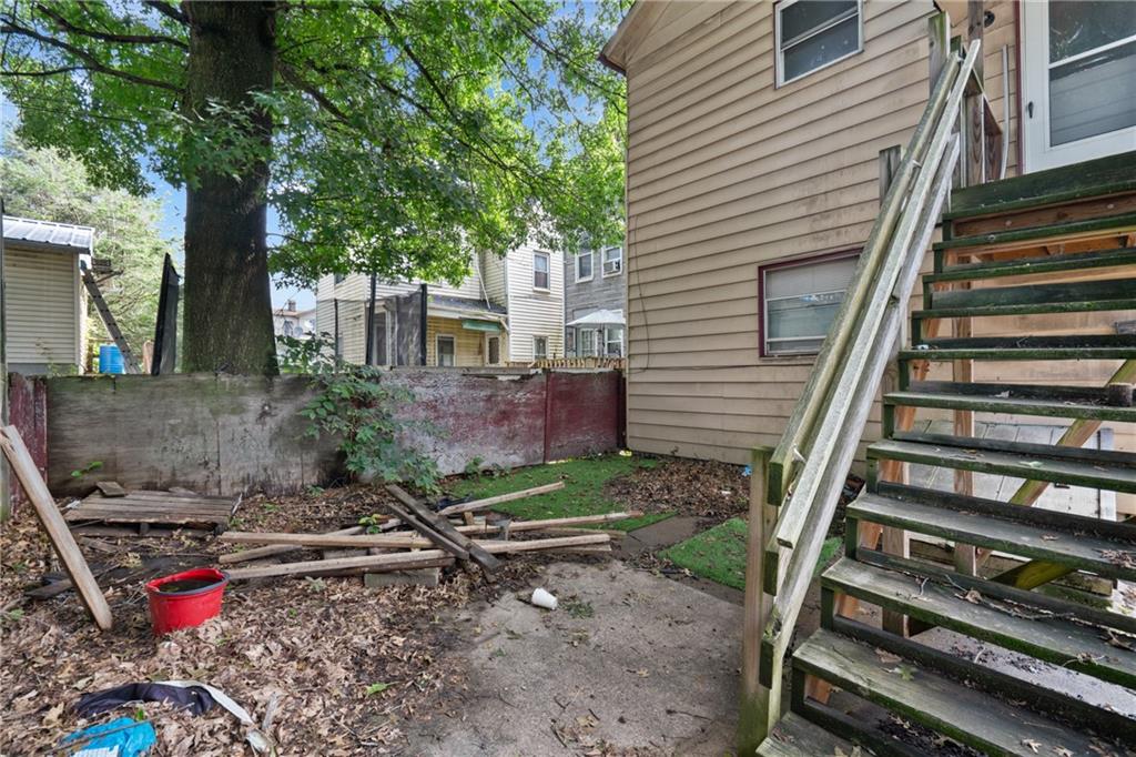 525 Larimer Avenue Turtle Creek, PA 15145 - Photo 26 of 28 a view of a backyard with chairs and a large tree