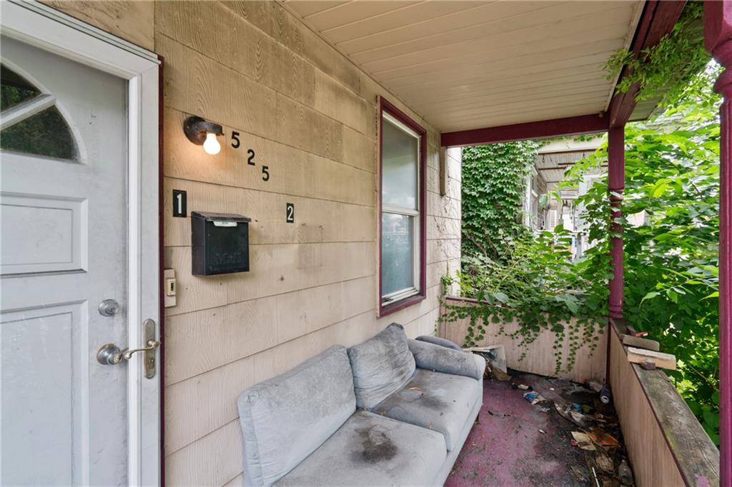 525 Larimer Avenue Turtle Creek, PA 15145 - Photo 3 of 28 a living room with furniture and a potted plant