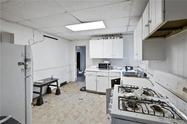 a kitchen with sink cabinets and appliances