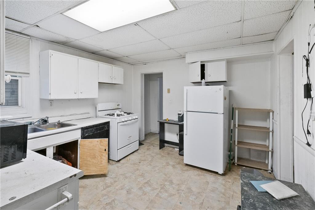 525 Larimer Avenue Turtle Creek, PA 15145 - Photo 8 of 28 a kitchen with a refrigerator sink and stove