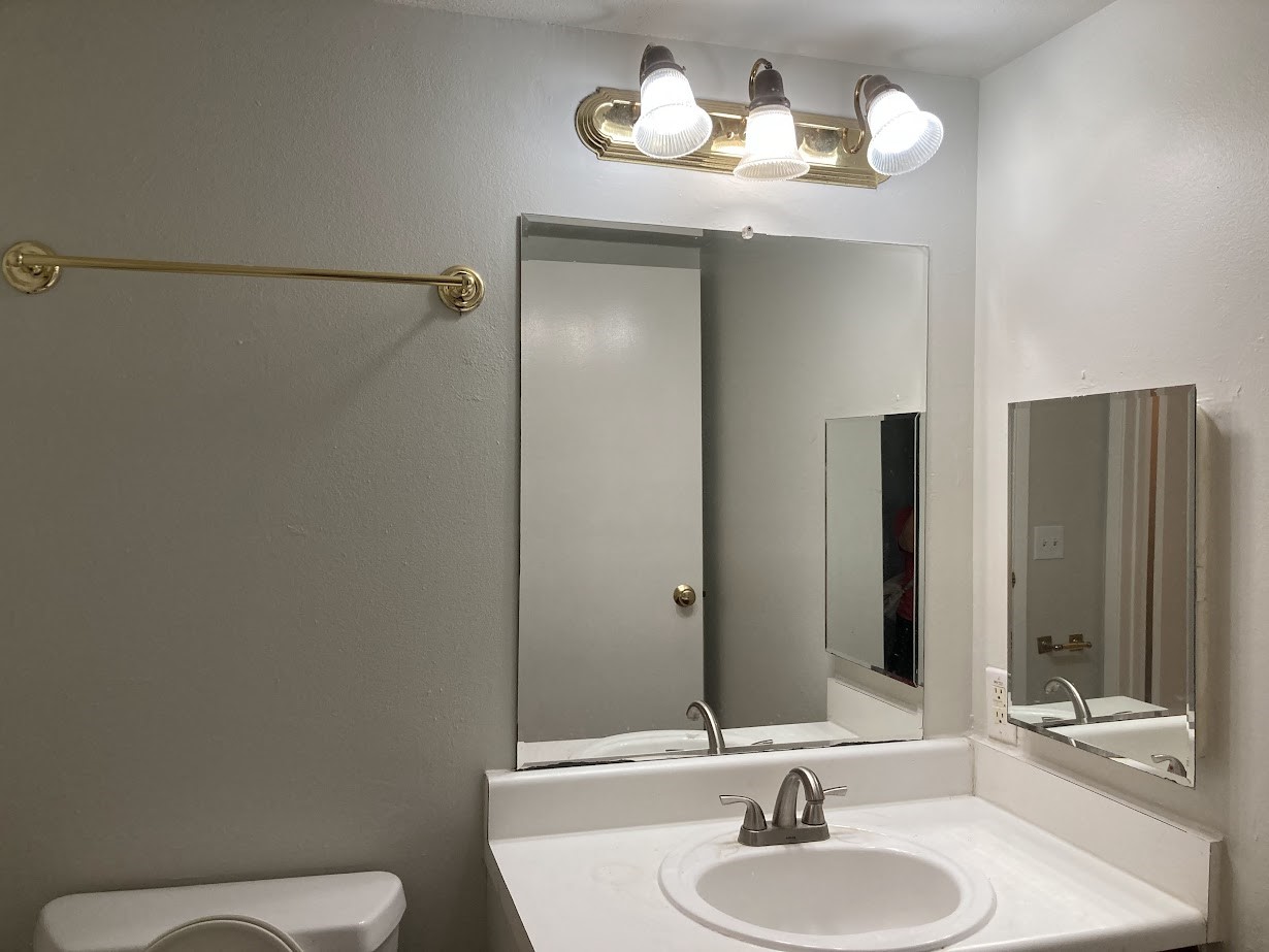 3075 Walnut Bend Lane, Unit 33 Houston, TX 77042 - Photo 19 of 25 a bathroom with a sink a toilet and mirror