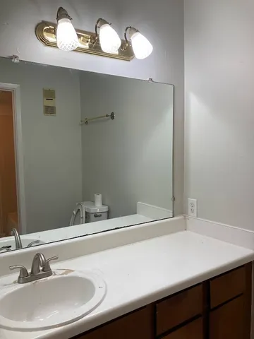 a bathroom with a sink and cabinets
