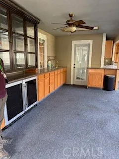 a view of an empty room with window and cabinet