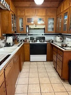 a large kitchen with stainless steel appliances granite countertop a stove a sink and a microwave
