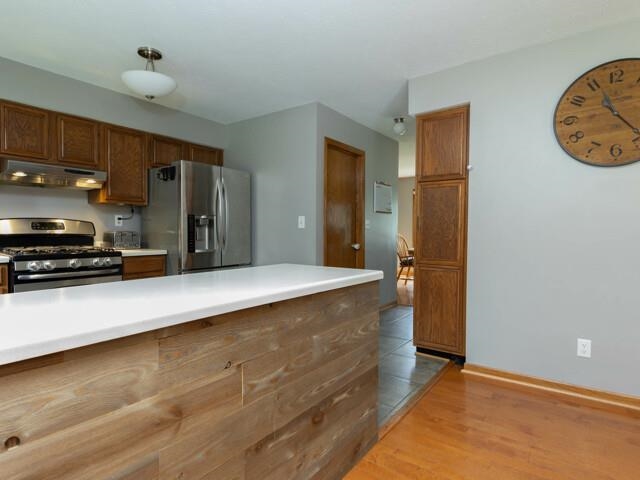 530 Pin Oak Road Rockton, IL 61072 - Photo 11 of 33 a large kitchen with kitchen island a counter top space a sink and stainless steel appliances