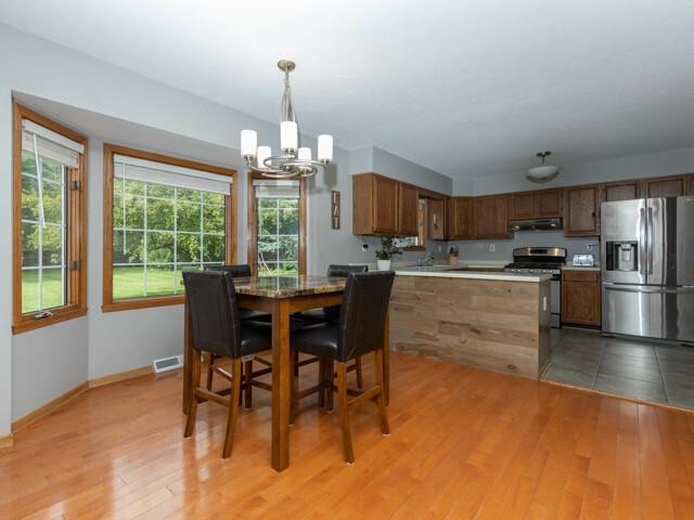 530 Pin Oak Road Rockton, IL 61072 - Photo 13 of 33 a kitchen with a dining table chairs and refrigerator