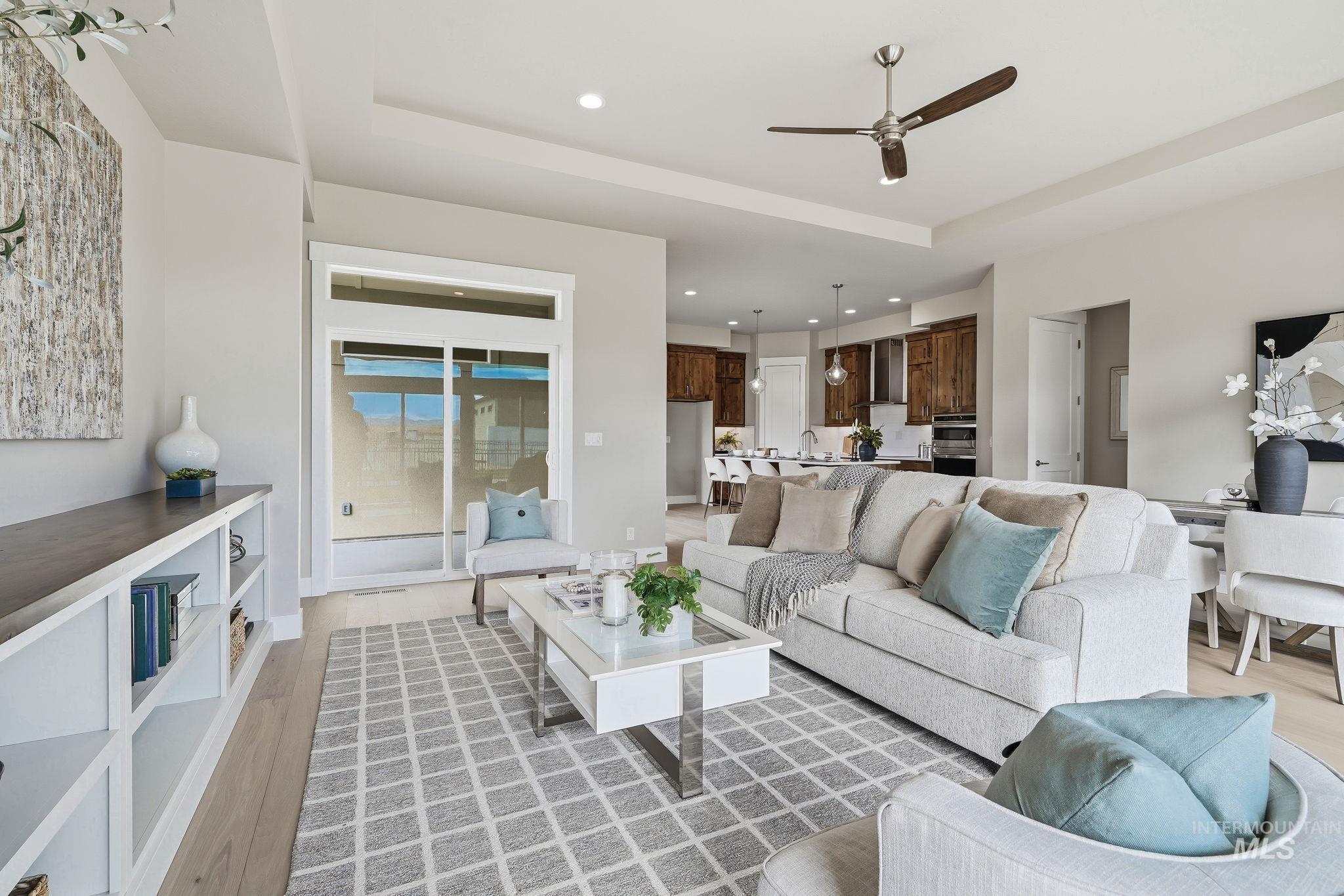 470 South Radiator Way Boise, ID 83716 - Photo 10 of 50 Spacious living area featuring light wood-finish flooring and a tray ceiling