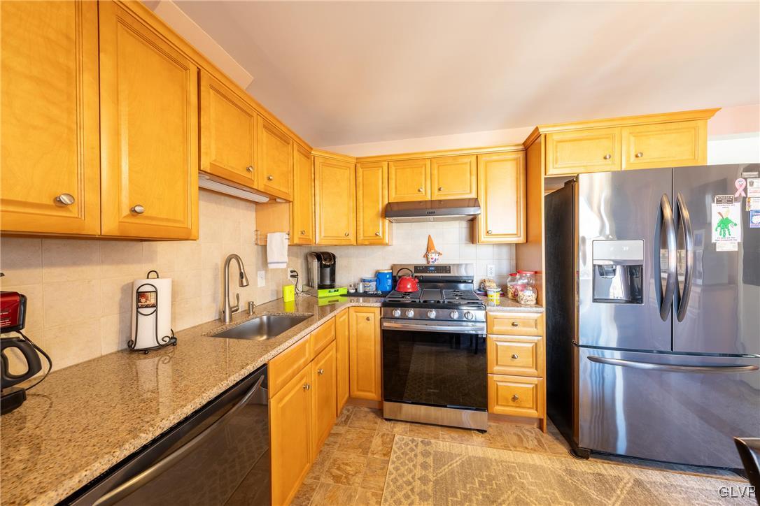 70 Colonial Road Allentown, PA 18109 - Photo 11 of 32 a kitchen with stainless steel appliances granite countertop a refrigerator sink and cabinets