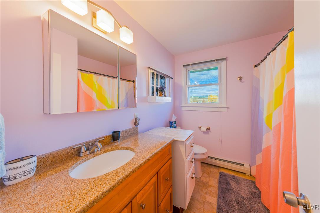 70 Colonial Road Allentown, PA 18109 - Photo 16 of 32 a bathroom with a granite countertop sink and a mirror