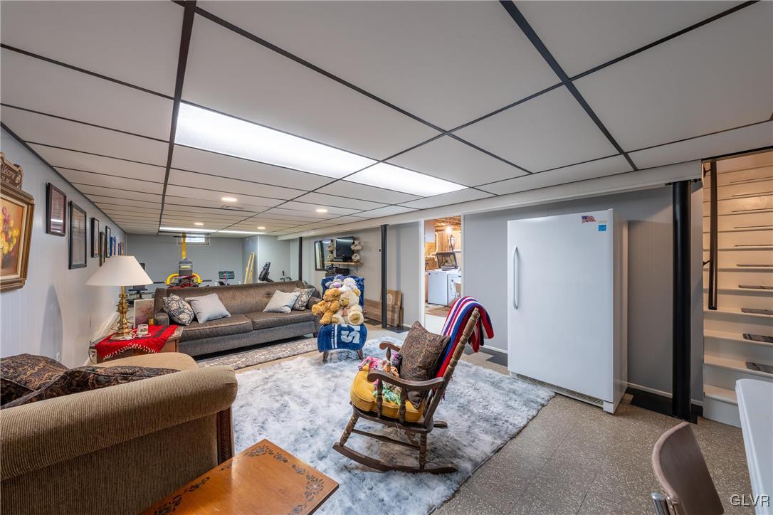 70 Colonial Road Allentown, PA 18109 - Photo 18 of 32 a living room with furniture a flat screen tv and a table