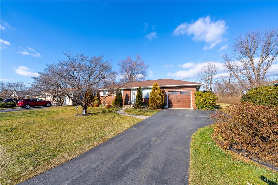 70 Colonial Road Allentown, PA 18109 - Photo 2 of 32 a front view of a house with a yard and garage