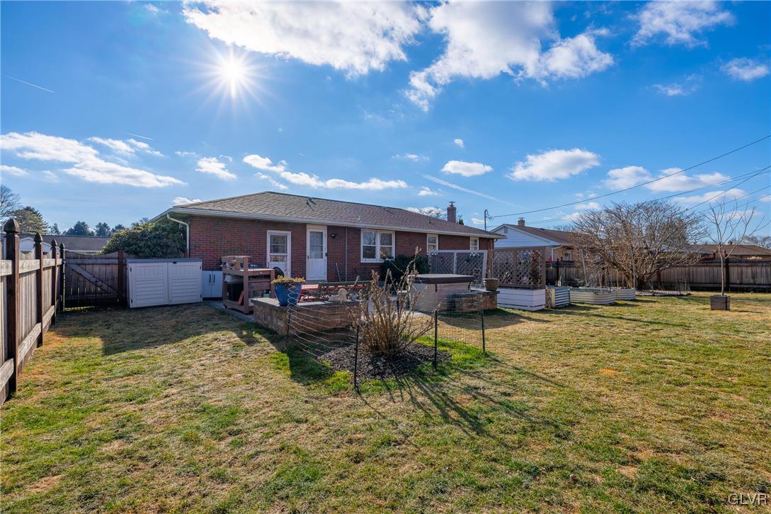 70 Colonial Road Allentown, PA 18109 - Photo 27 of 32 a view of a swimming pool with couches and table under an umbrella