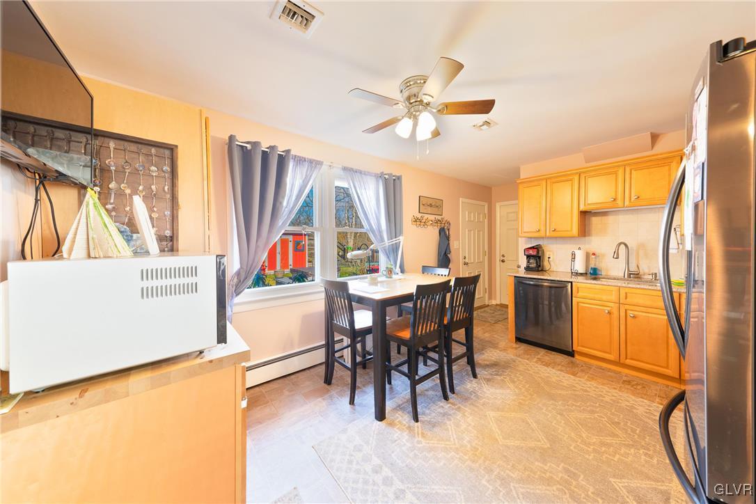 70 Colonial Road Allentown, PA 18109 - Photo 10 of 32 a living room with stainless steel appliances dining table a chimney a sink and cabinets