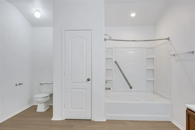 a bathroom with a granite countertop sink toilet and a mirror