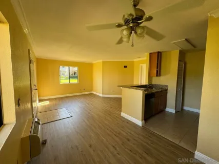 a view of a kitchen with a sink and a refrigerator