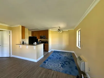 a hallway with cabinets and wooden floor