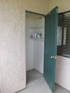 an empty room with closet and wooden floor