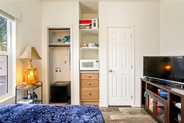 a bedroom with a bed and flat screen tv