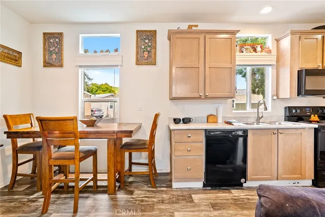 a view of a dining room with furniture and a kitchen