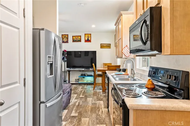 a kitchen with stainless steel appliances granite countertop a refrigerator stove and sink