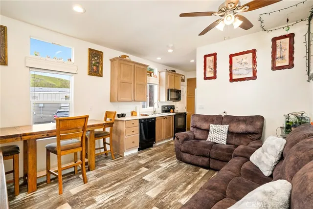 a living room with furniture kitchen and a window