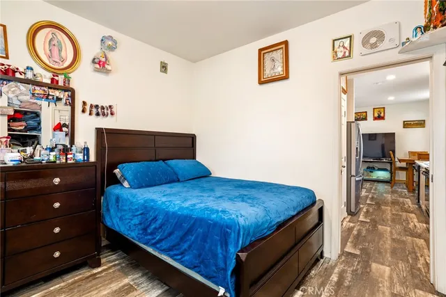a bedroom with a bed and a table with a bookshelf