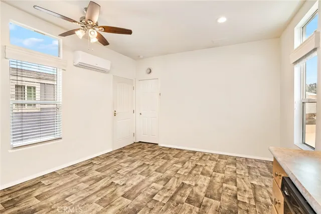 a view of empty room with window and ceiling fan