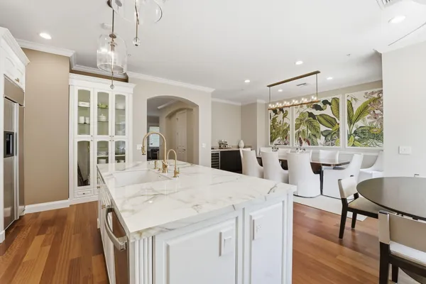 a kitchen with white cabinets and appliances