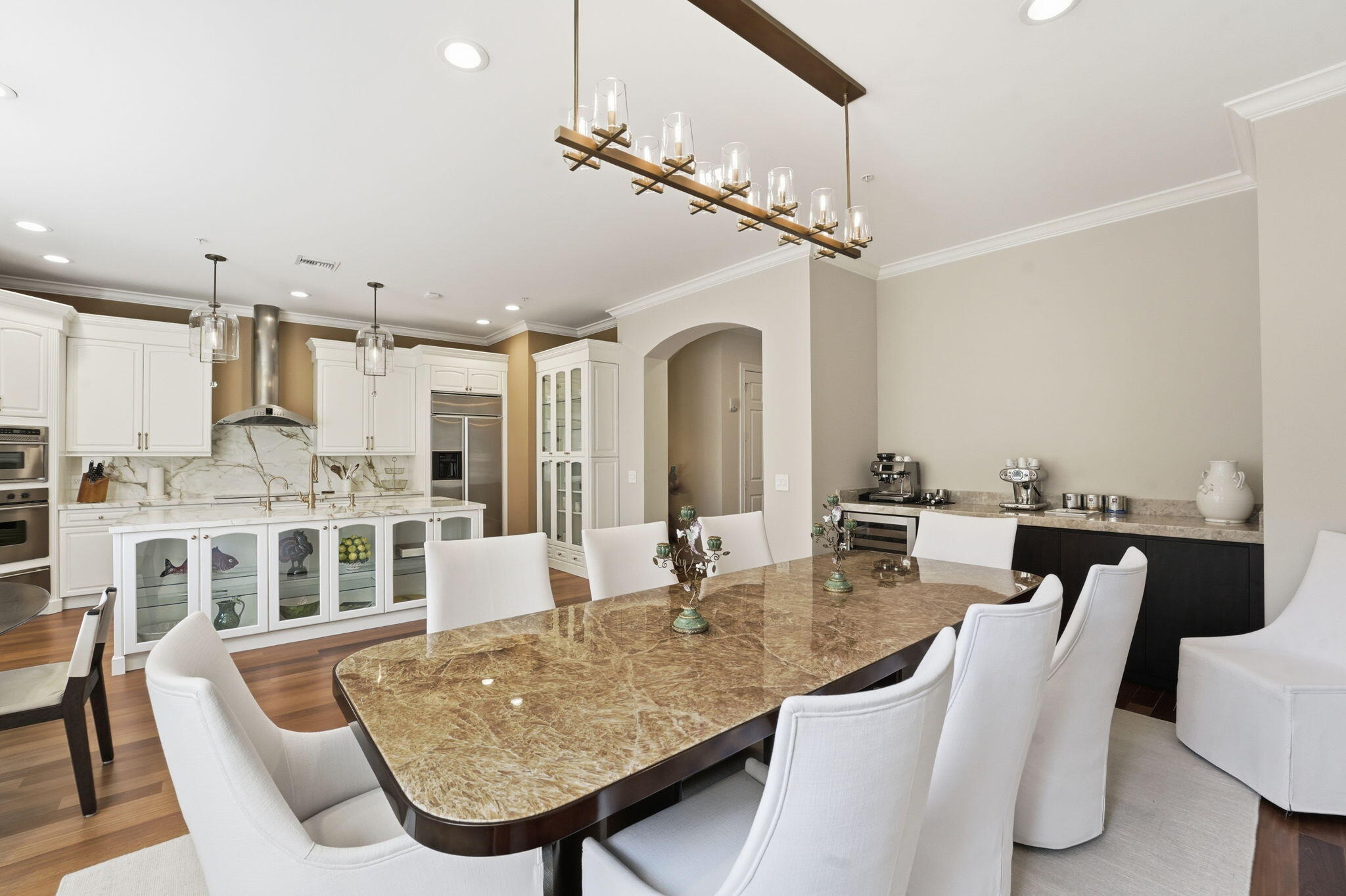 921 Osceola Drive, Unit 2 Boca Raton, FL 33432 - Photo 17 of 69 a dining room with furniture a chandelier and kitchen view