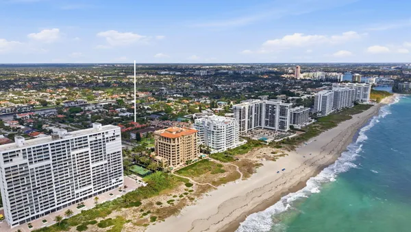 a front view of a house with lots of green space