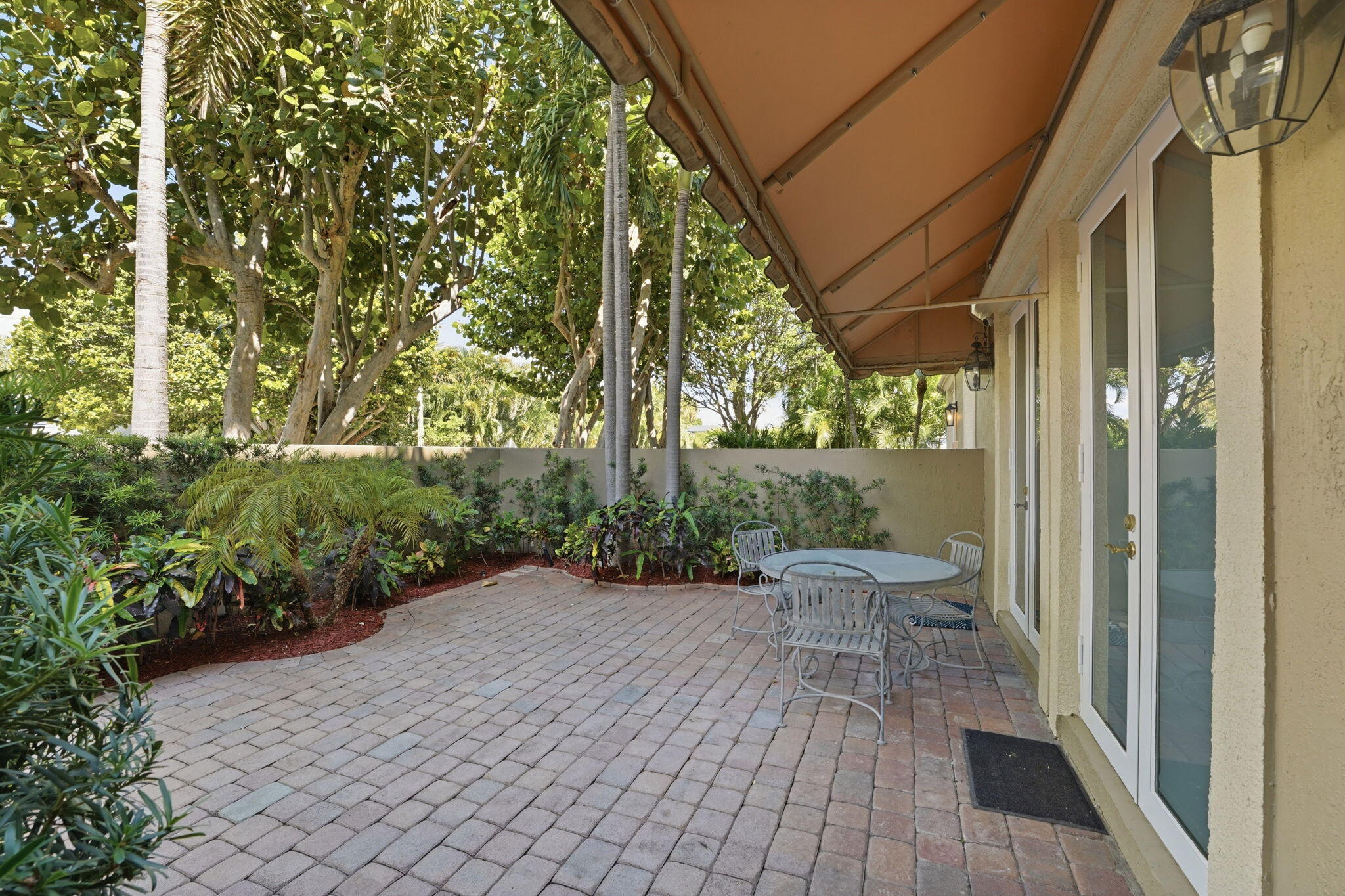 921 Osceola Drive, Unit 2 Boca Raton, FL 33432 - Photo 53 of 69 a view of a patio with table and chairs and potted plants