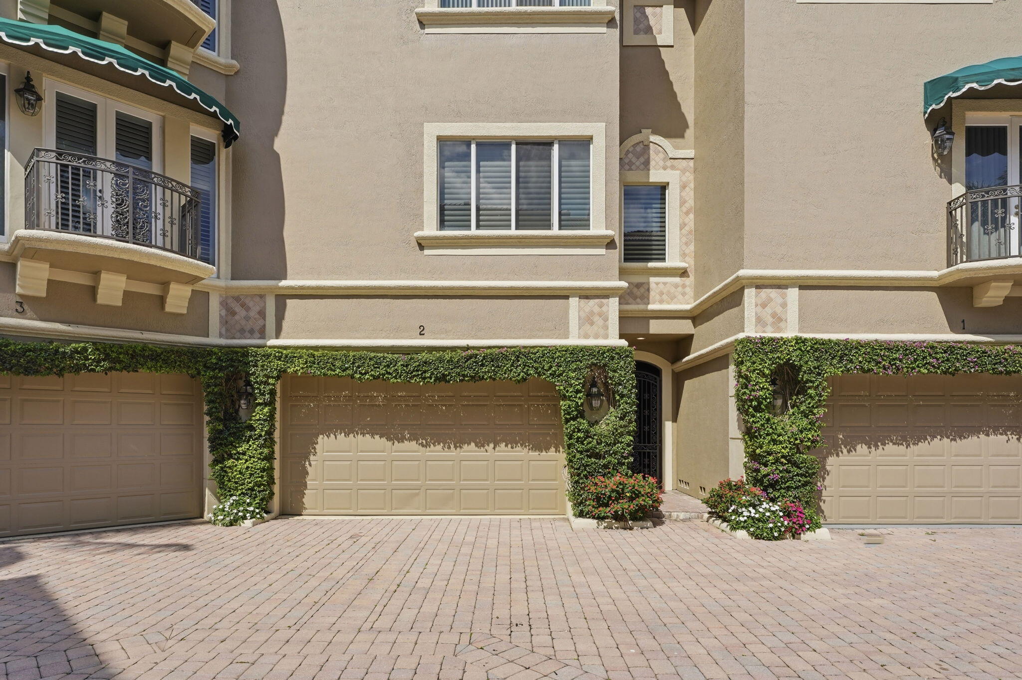921 Osceola Drive, Unit 2 Boca Raton, FL 33432 - Photo 59 of 69 a front view of a house with a yard and garage