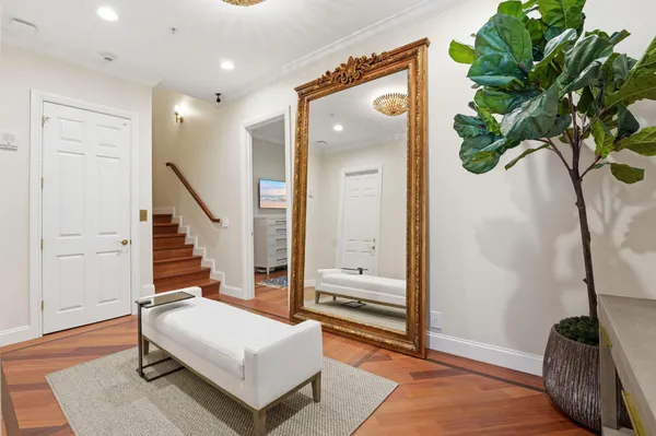 a bedroom with a large bed and wooden floor