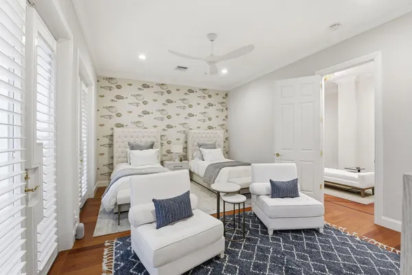 a bathroom with a toilet sink vanity granite and shower