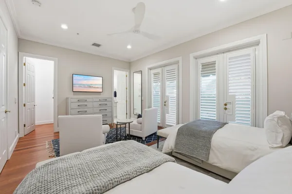 a large kitchen with stainless steel appliances kitchen island granite countertop a table chairs and a wooden floor