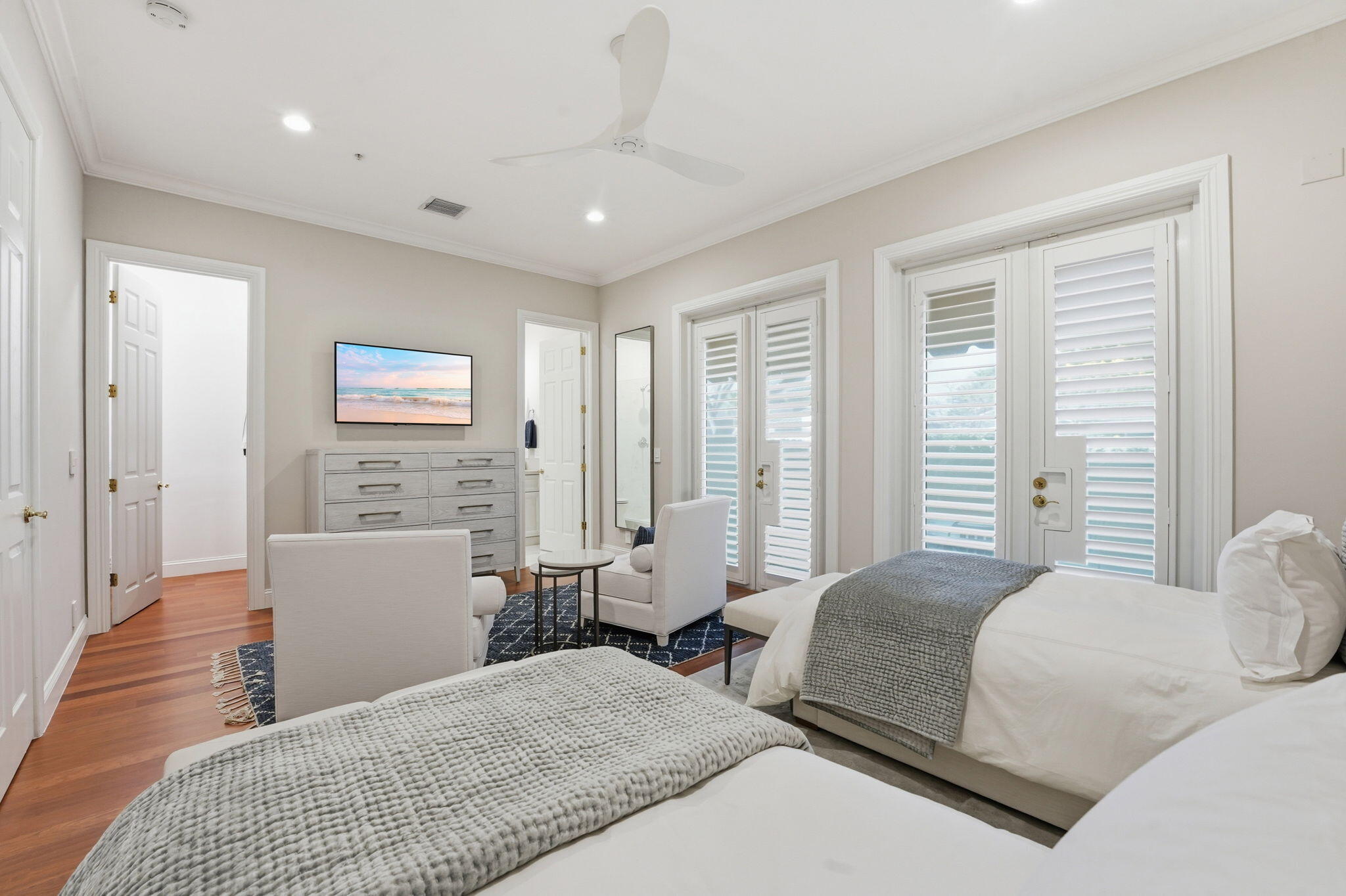 921 Osceola Drive, Unit 2 Boca Raton, FL 33432 - Photo 8 of 69 a bedroom with a large bed and wooden floor