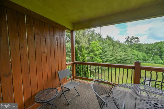 a view of a chair and table in the balcony