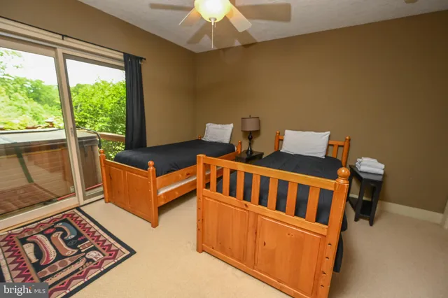 a view of a livingroom with furniture and a ceiling fan