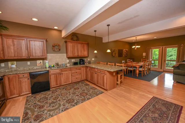 a large kitchen with stainless steel appliances and a large counter top