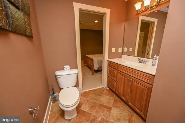 a bathroom with a toilet sink and mirror