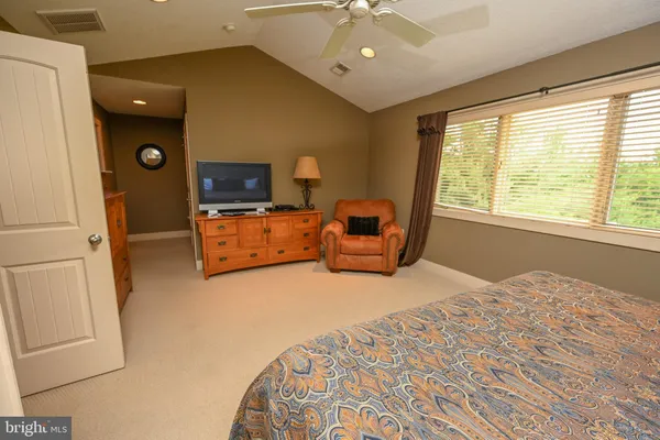 a bedroom with furniture and flat screen tv