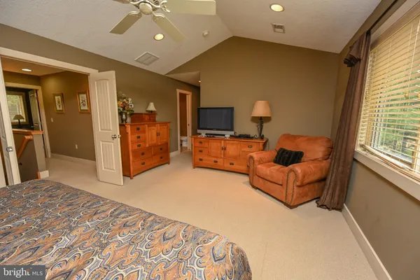 a bedroom with furniture and a flat screen tv