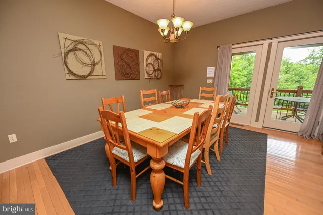 a view of a dining room with furniture wooden floor and chandelier
