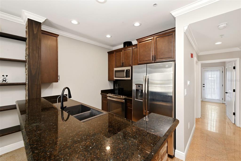 709 Bloom Street, Unit 160 Celebration, FL 34747 - Photo 13 of 35 a kitchen with stainless steel appliances granite countertop a refrigerator and a sink