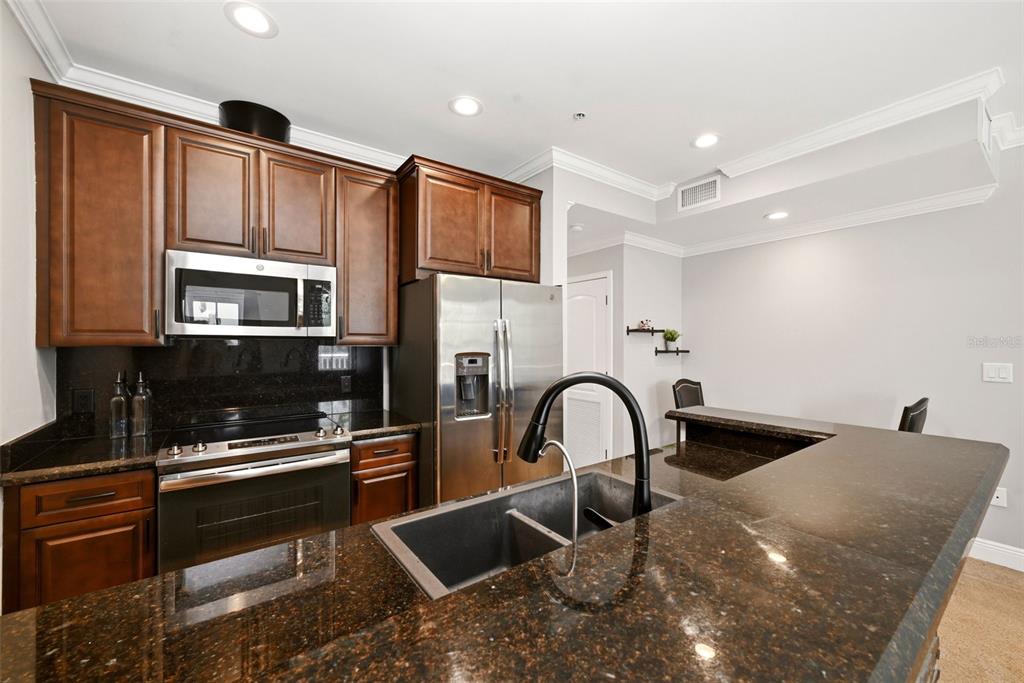 709 Bloom Street, Unit 160 Celebration, FL 34747 - Photo 14 of 35 a kitchen with a refrigerator and a sink
