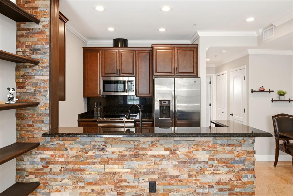 709 Bloom Street, Unit 160 Celebration, FL 34747 - Photo 10 of 35 a view of kitchen with stainless steel appliances kitchen island granite countertop a refrigerator and cabinets